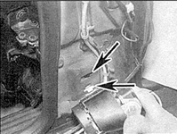 1. Установите язычок натяжного барабана в вырез на стойке кузова (указан стрелкой).